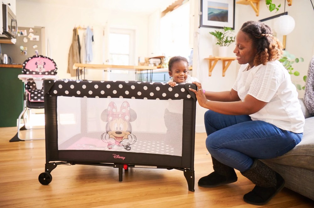 Disney Baby 3D Ultra Baby Play Yard with Bassinet and Toy Bar. Peeking Minnie